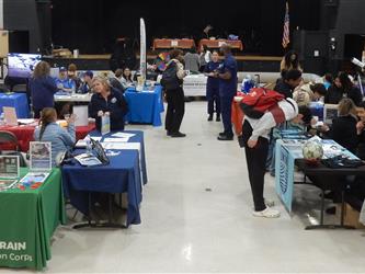 Photo of students and professionals engaged in Service and Career Fair