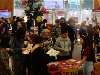 Photo of students and college representatives engaged in College Fair